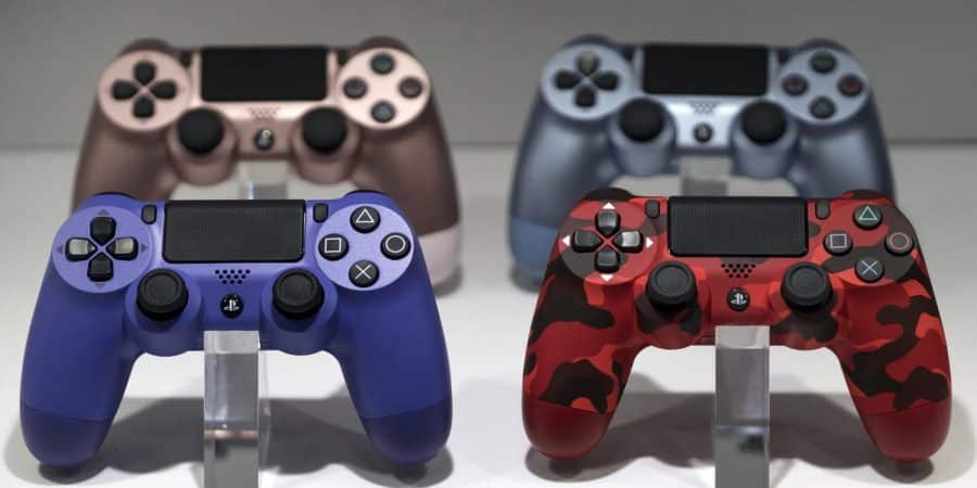 wireless controllers for the playstation 4 ps4 game console are displayed in the sony interactive