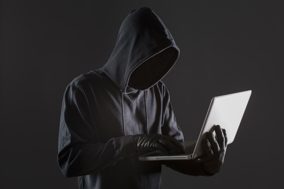 side view male hacker with gloves laptop